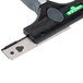A Unger ErgoTec Ninja 2-in-1 glass scraper with a green and black blade and handle.