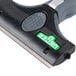 A close up of a Unger ErgoTec Ninja 4" black and green window scraper.