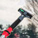 A Unger ErgoTec Ninja glass scraper with a razor blade being used to clean a window.