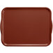 A brown rectangular Cambro tray with handles on a table.