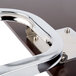 A metal tablet arm with a wood surface and metal frame.