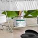 A can of Choice 4 Hour Wick Chafing Dish Fuel with a safety twist cap placed under a chafing dish rack.