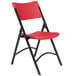 A National Public Seating black metal folding chair with red plastic back and seat.