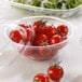 A Sabert clear plastic bowl filled with tomatoes and lettuce.