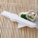 White plastic tongs picking up a sushi roll.