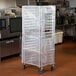 A white translucent plastic cover on a bun pan rack.