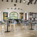 A FLAT Tech round black cast iron table base in a room with tables and chairs.