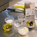 An Arcoroc clear glass bowl with white substance in it on a kitchen counter.