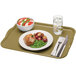 A Cambro rectangular olive green fiberglass cafeteria tray with food on it and a fork.