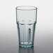 A clear plastic tumbler with a blue rim.