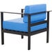 A black outdoor armchair with a blue cushion and black aluminum frame.