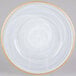 A white Charge It by Jay glass charger plate with a gold rim.