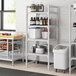 A Cambro Premium Camshelving unit with vented shelves holding food containers.