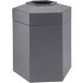 A gray hexagonal waste container with an open top.