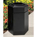 A black hexagonal Commercial Zone trash can with an open top.