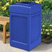 A blue rectangular Commercial Zone PolyTec waste container next to a bench.