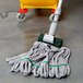 A Unger SmartColor microfiber string mop head on a mop handle.