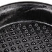 A close up of an 8" black polyethylene tortilla server with holes.