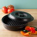 A black polyethylene tortilla server with a circle in the center.