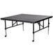 A National Public Seating Transfix stage on a black rectangular table with wheels.