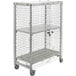 A Cambro Camshelving® mobile security cage with shelves on wheels.