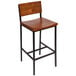 A BFM Seating Memphis bar height chair with a wooden back and seat and metal legs.