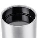 A stainless steel cylindrical wall mounted cigarette and ash receptacle with a black lid.