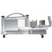 A Nemco tomato slicer machine with a piece of food on top.