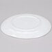 A white GET Urban Mill coupe plate with a circular design on a gray surface.