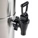 A Grindmaster stainless steel iced tea dispenser with a black valve.