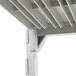 A close-up of a white plastic shelf from a Cambro Camshelving® Premium Unit.