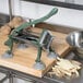 A Choice Prep 3/8" French Fry Cutter on a cutting board next to potatoes.