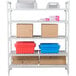 A white Cambro Camshelving® Premium shelving unit with vented shelves holding boxes and containers.