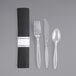 A black pre-rolled napkin with clear plastic cutlery inside.