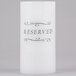 A white Sterno wax pillar candle with a black "Reserved" label.