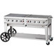 A large stainless steel Crown Verity portable grill on wheels.