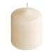 A case of 12 ivory wax pillar candles with a single candle on top.