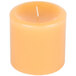 A close up of a yellow Sterno beeswax pillar candle.
