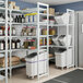 A white Cambro Camshelving® Premium stationary add-on shelving unit with 3 vented shelves and 1 solid shelf.