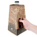 A hand opening a box of a 96 oz. carafe with a white background.