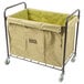 A large tan and black Lavex Commercial laundry cart with black metal frame and wheels.