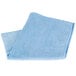 a blue towel folded on a white surface