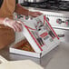 A man holding a Choice white corrugated pizza box.