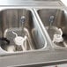 A stainless steel Spaceman soft serve ice cream machine on a counter with two hoppers.