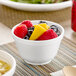 A close-up of a bowl of soup in a Dart white foam container.