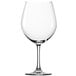A close-up of a clear Stolzle Burgundy wine glass with a stem.