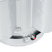 A close up of a silver cylinder with a red lid on a Hobart commercial garbage disposer.
