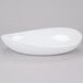 A close up of a white oval shaped GET Osslo melamine bowl.