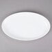 A white oval GET Osslo melamine platter with a white rim.