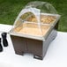 A Sterno Copper Vein chafing dish with clear dome lid and two half size pans on a table.